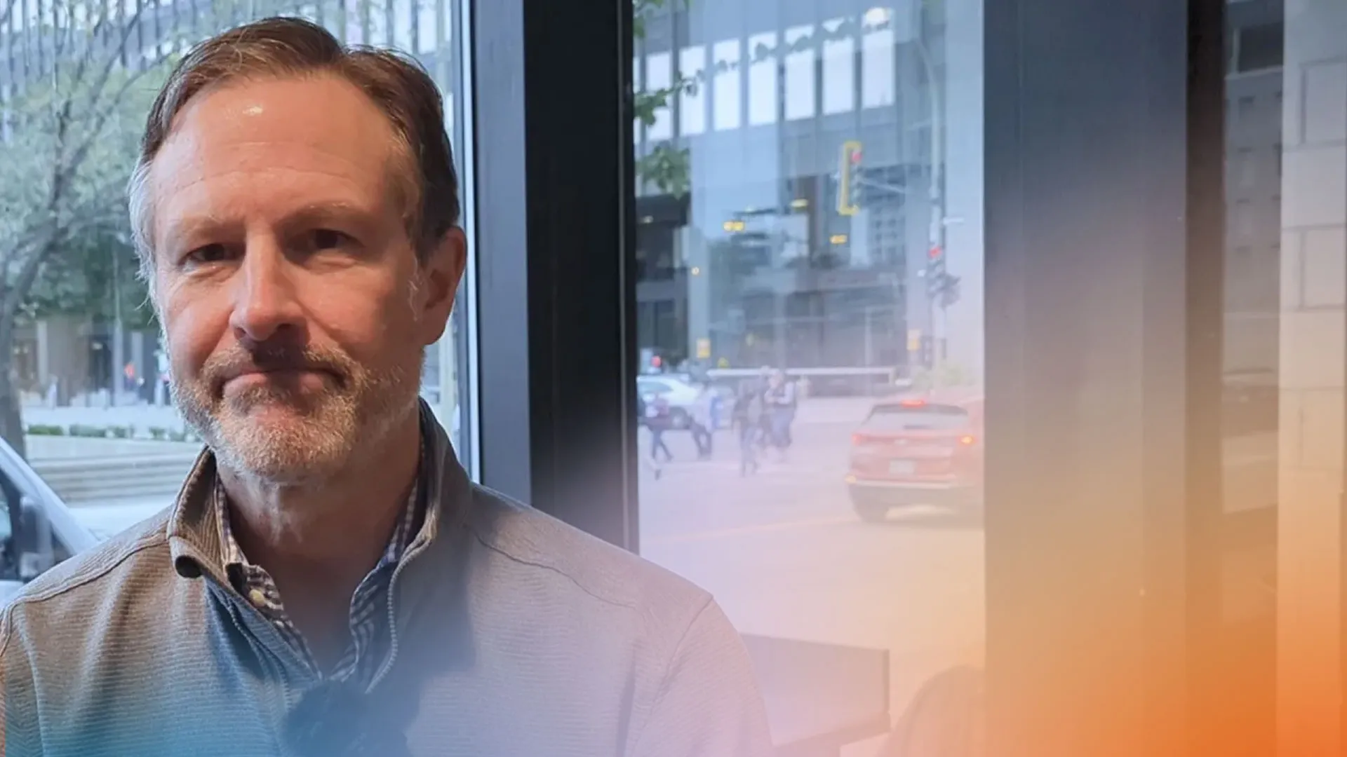 Photo of James Hughes addressing the camera at Café Mission Keurig.