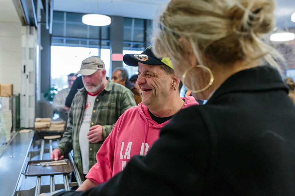 smiling man getting a meal at a cafeteria