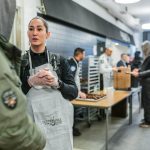 police woman speaking with a homeless man in a shelter