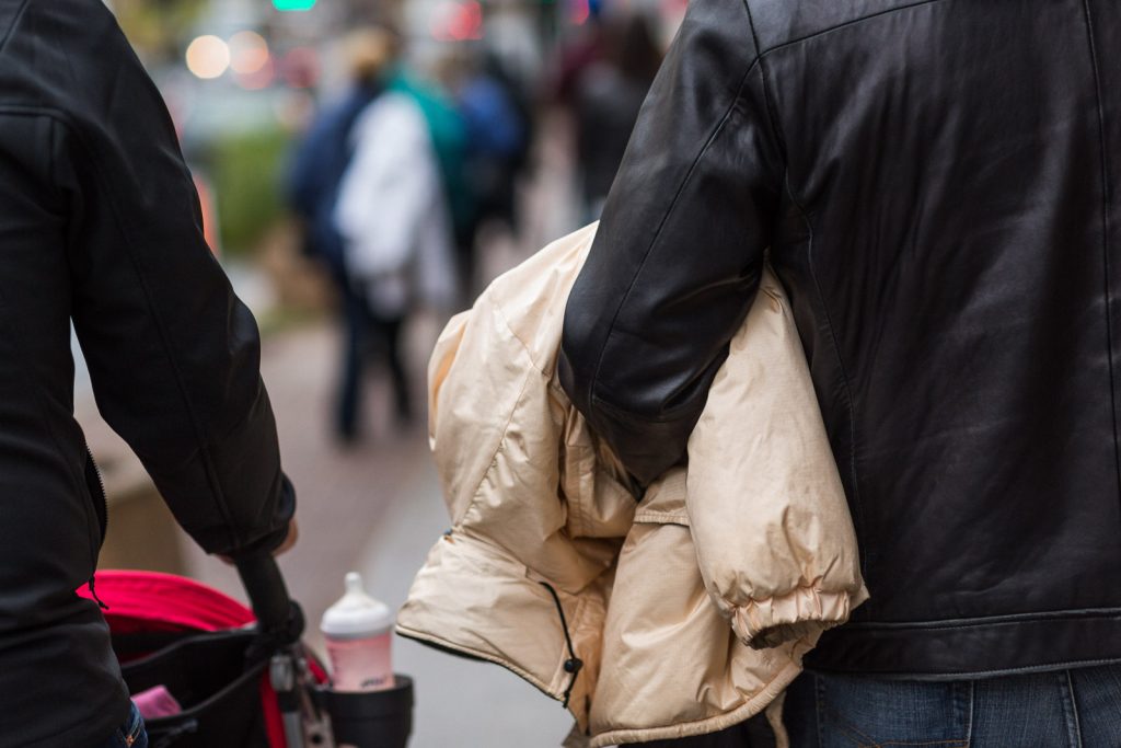 person carrying a coat on the street